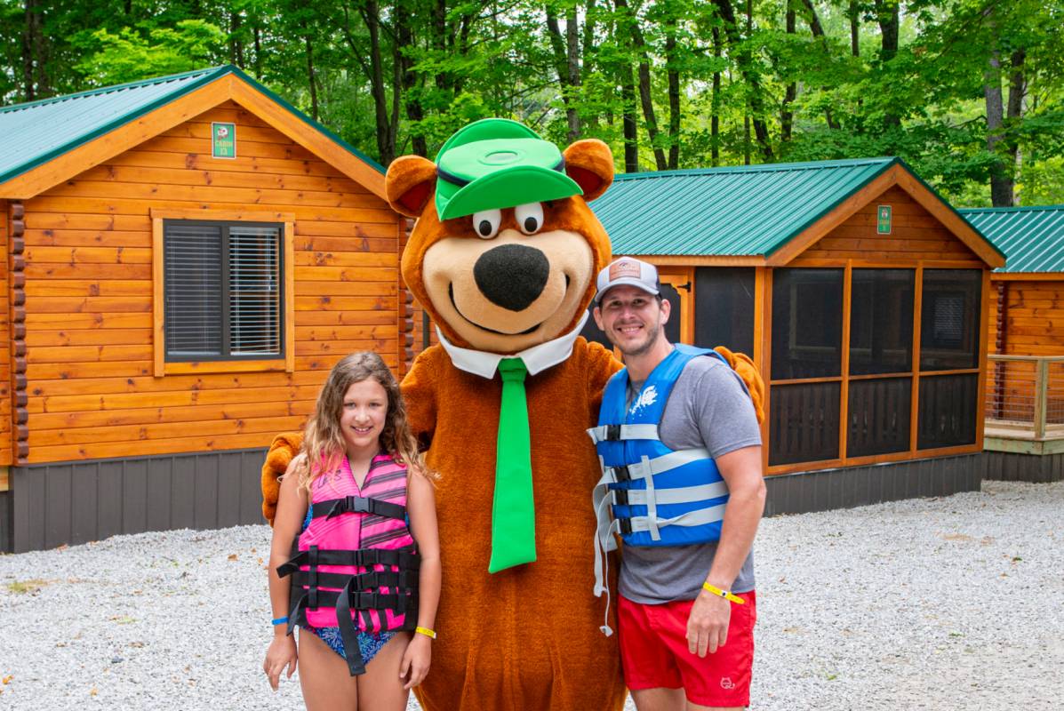 YOGI BEAR™ with family at cabins